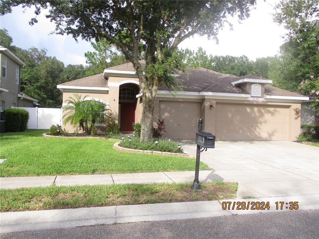 a front view of a house with garden