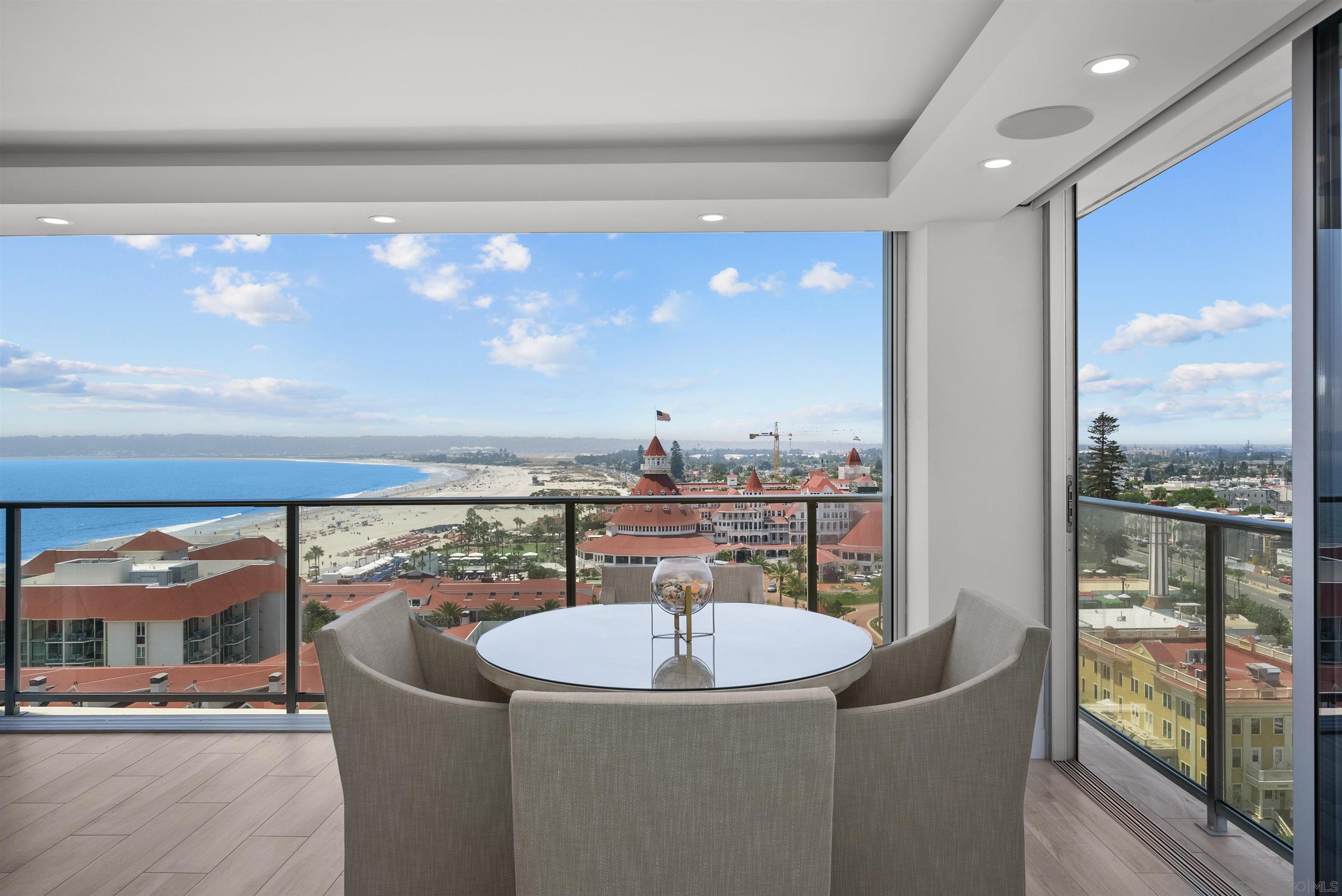 a dining room with furniture and a floor to ceiling window