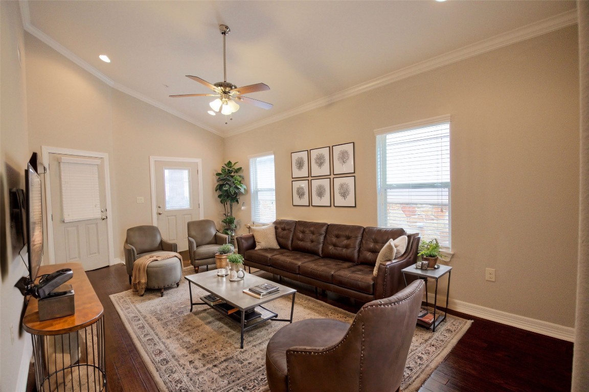 a living room with furniture ceiling fan and a window