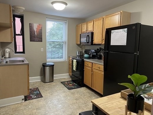 a kitchen with refrigerator and window