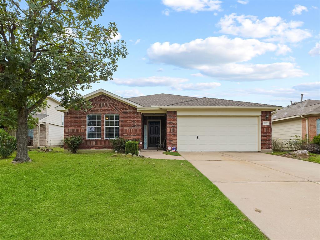 a front view of house with yard and green space