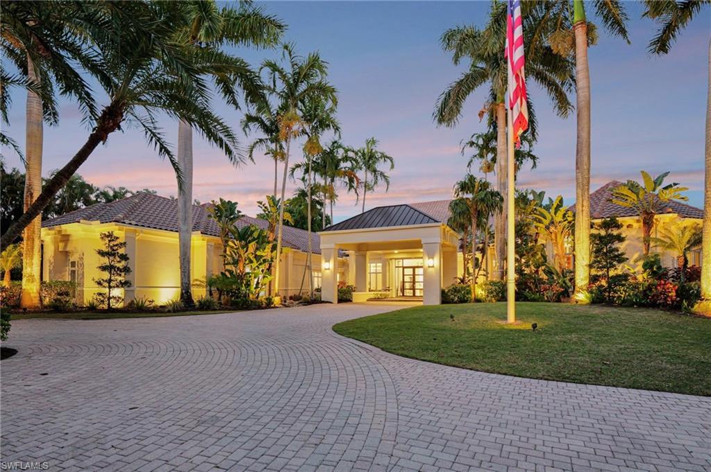 front view of a house with a yard and potted plants