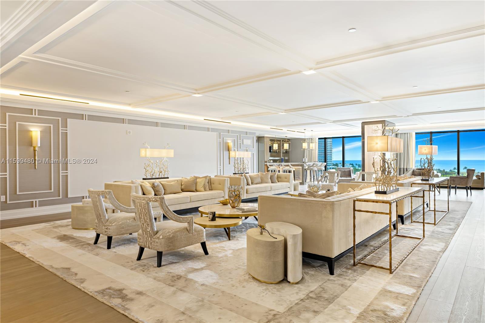 a living room with lots of white furniture and a table