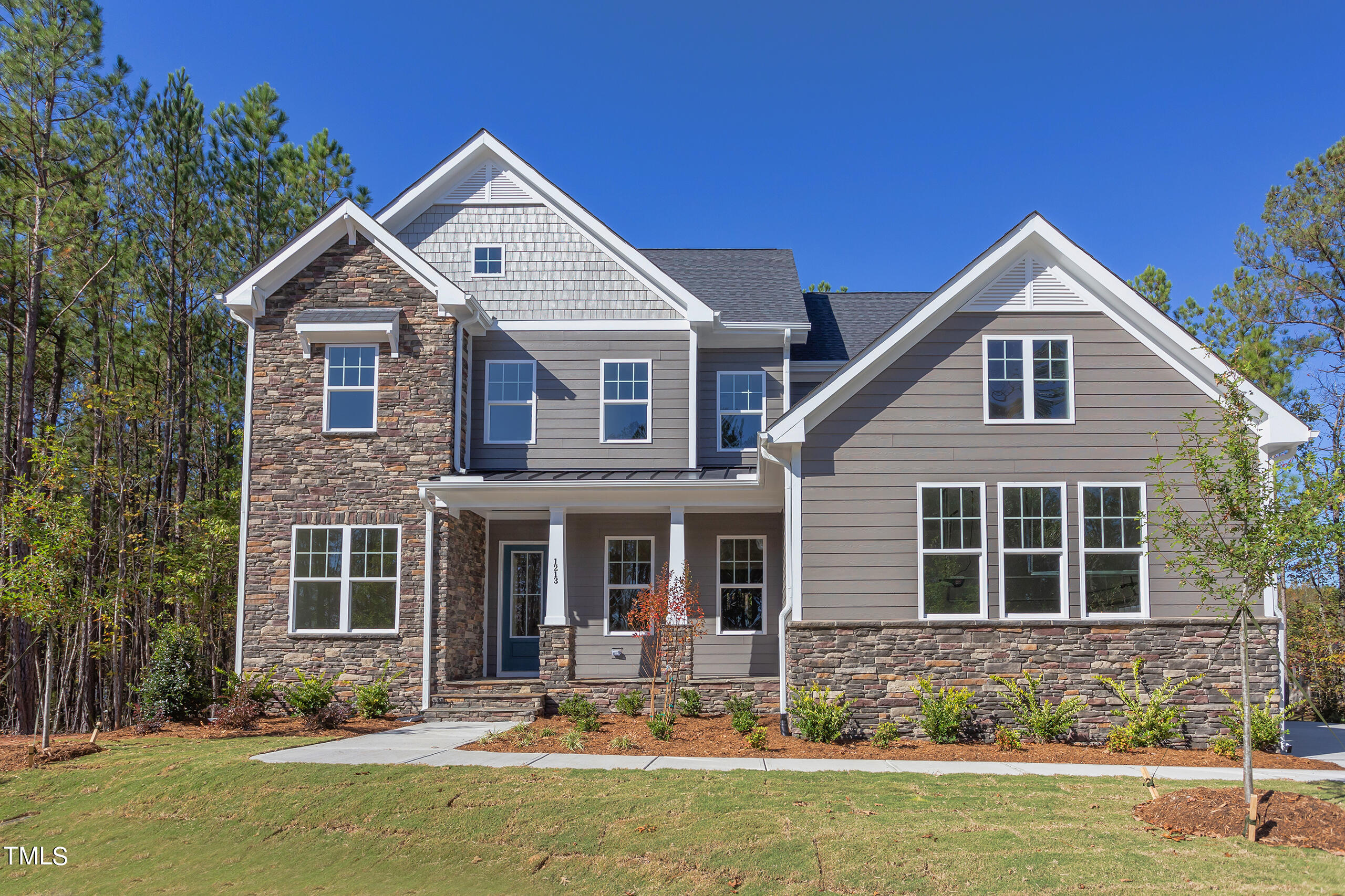 a front view of a house with yard and windows