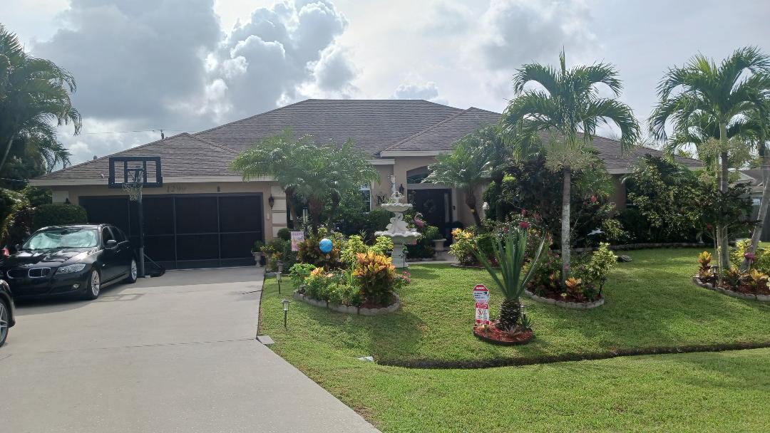 a view of a house with backyard and sitting area