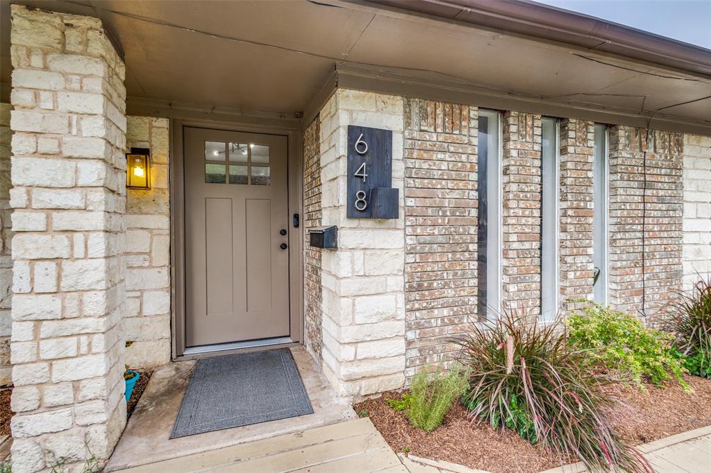 a view of front door of house with potted plant