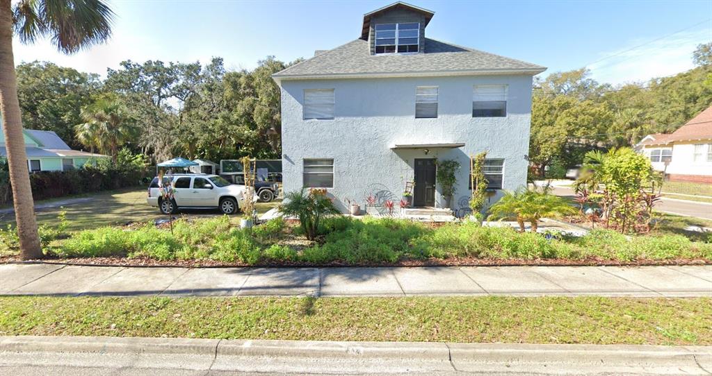 a front view of a house with a yard garage and outdoor seating