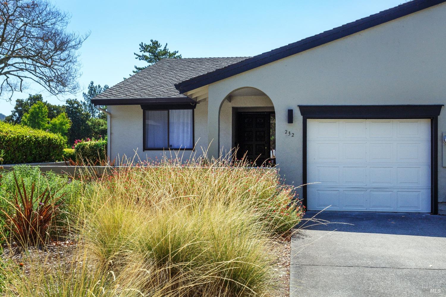 a front view of house along with pathway and a yard