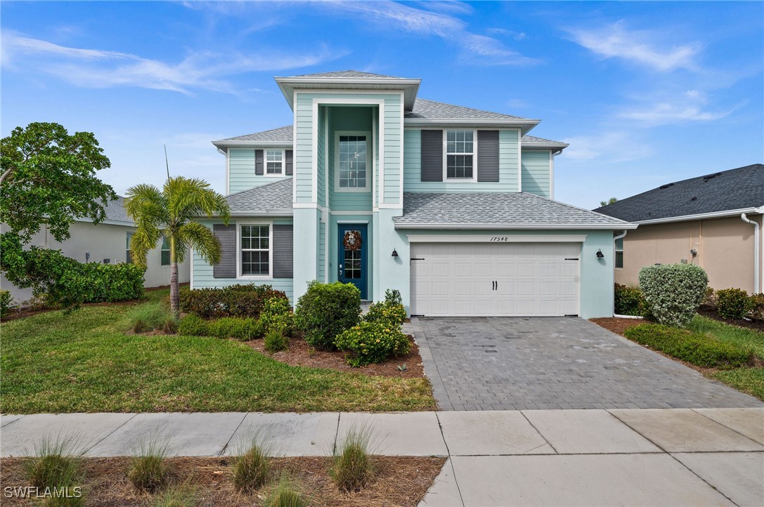 a front view of a house with a yard and garage