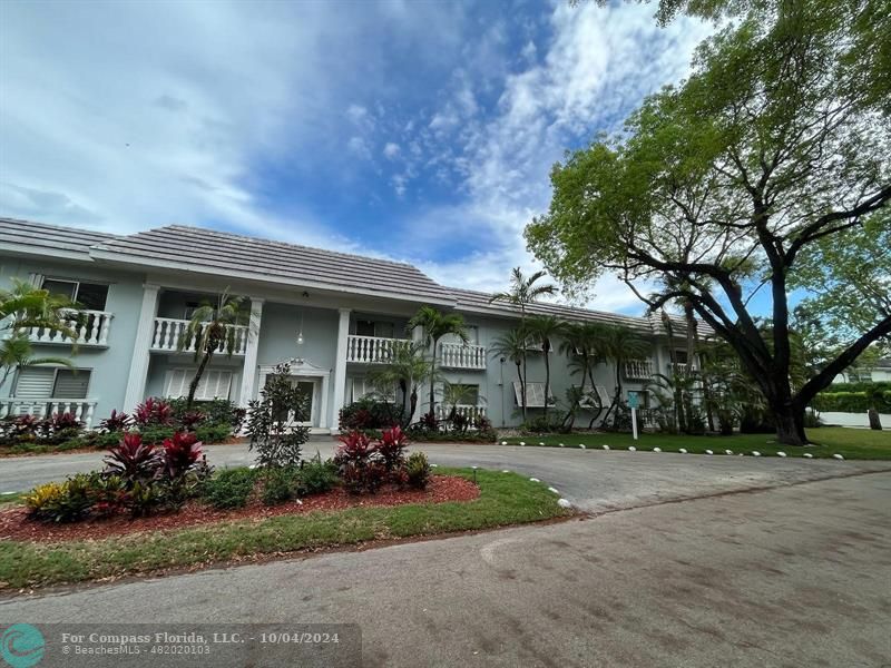 a front view of a house with a garden and plants