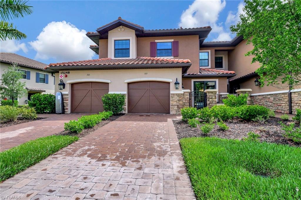 a front view of a house with a yard and garage