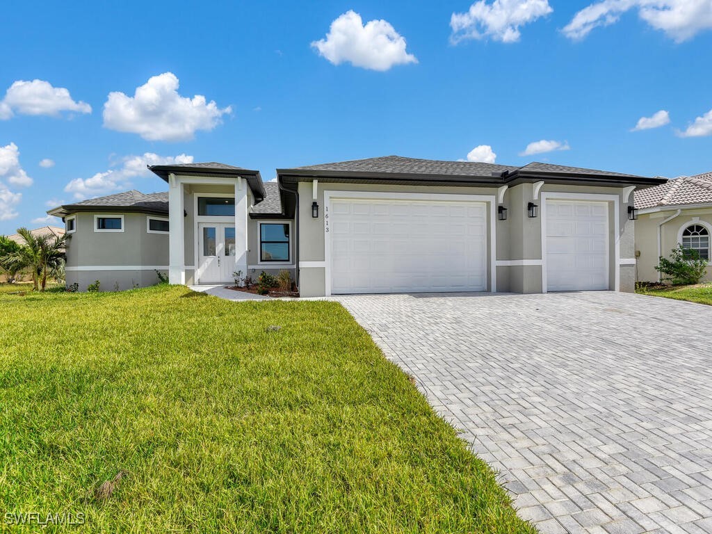 a front view of a house with a yard and garage