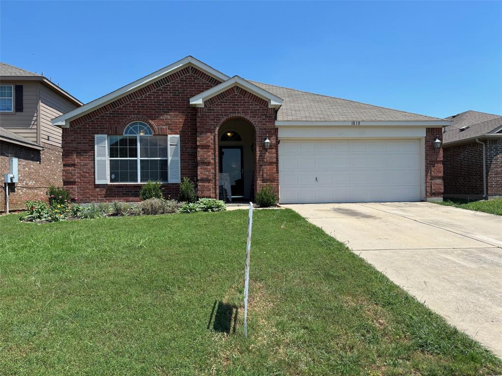 a front view of a house with a garden and yard