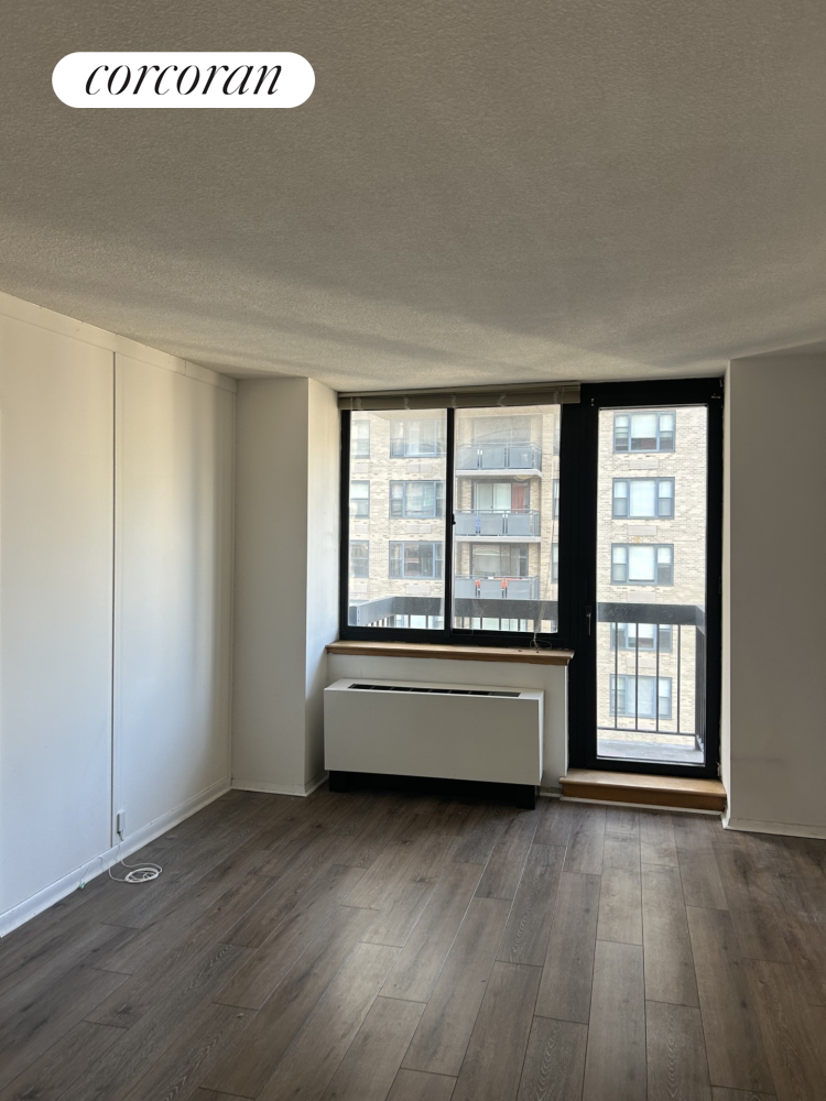 a living room with hard wood floors and a window