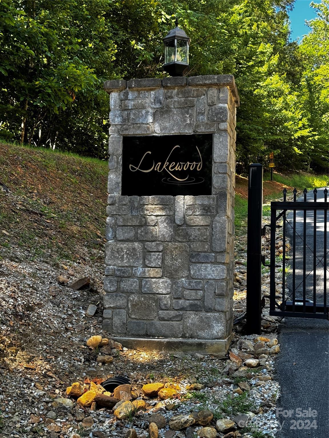 a sign board with wooden fence