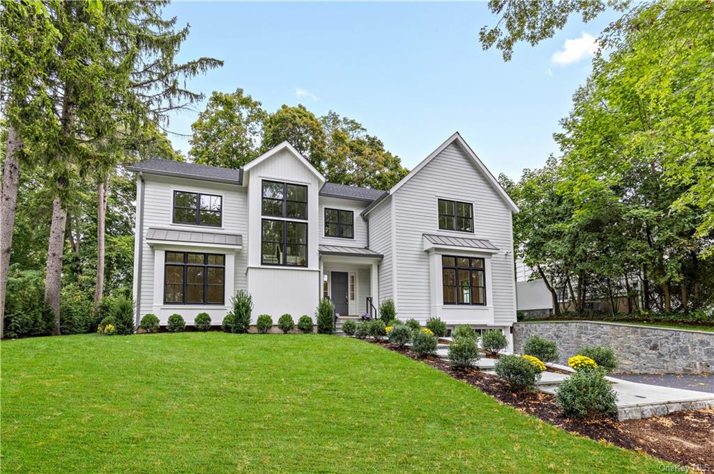 a front view of house with yard and green space