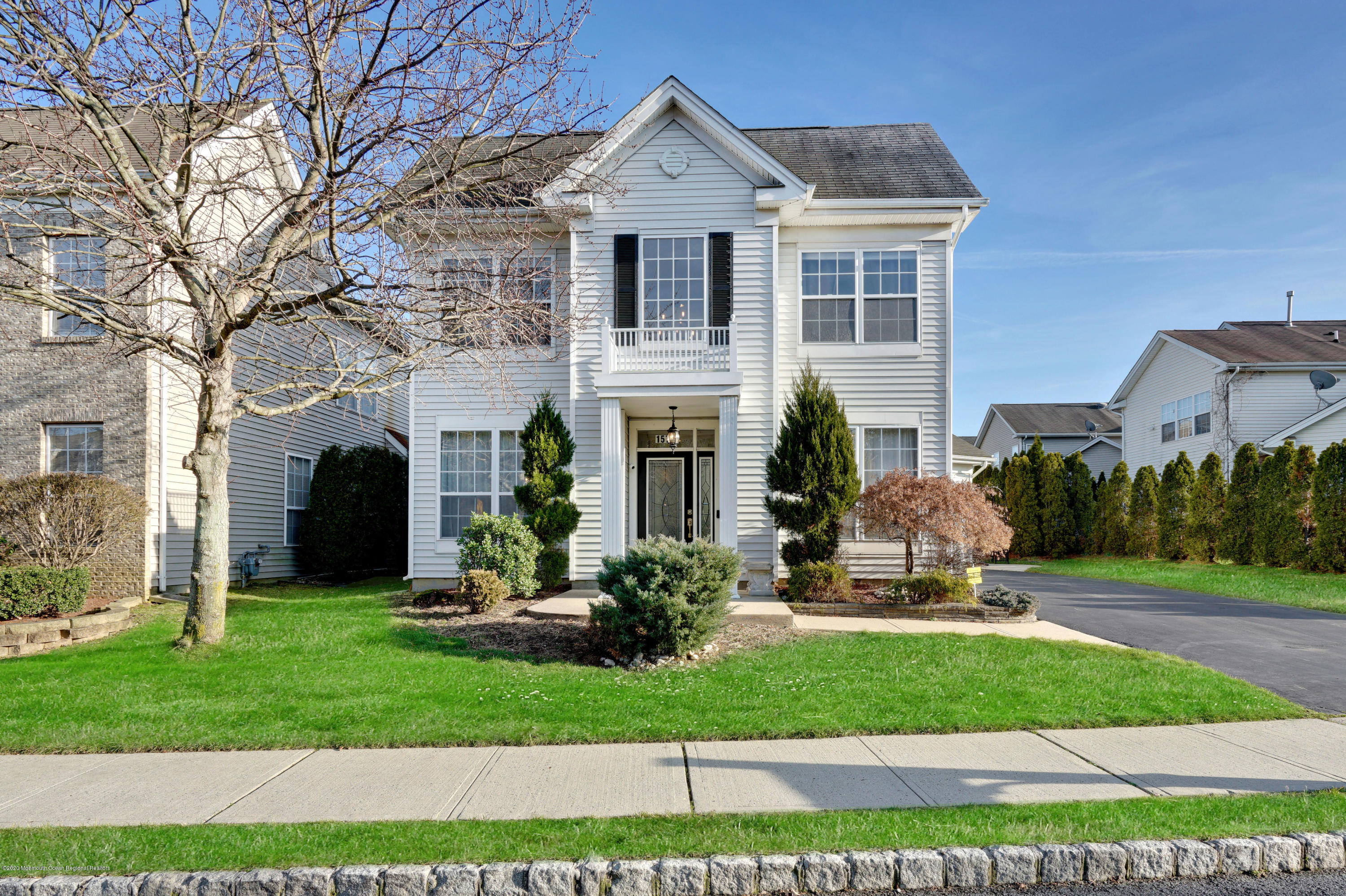 a front view of a house with a garden and plants