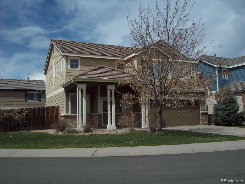 a front view of a house with a garden and plants