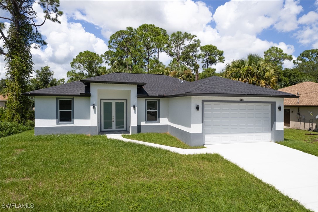 a front view of a house with a yard and garage