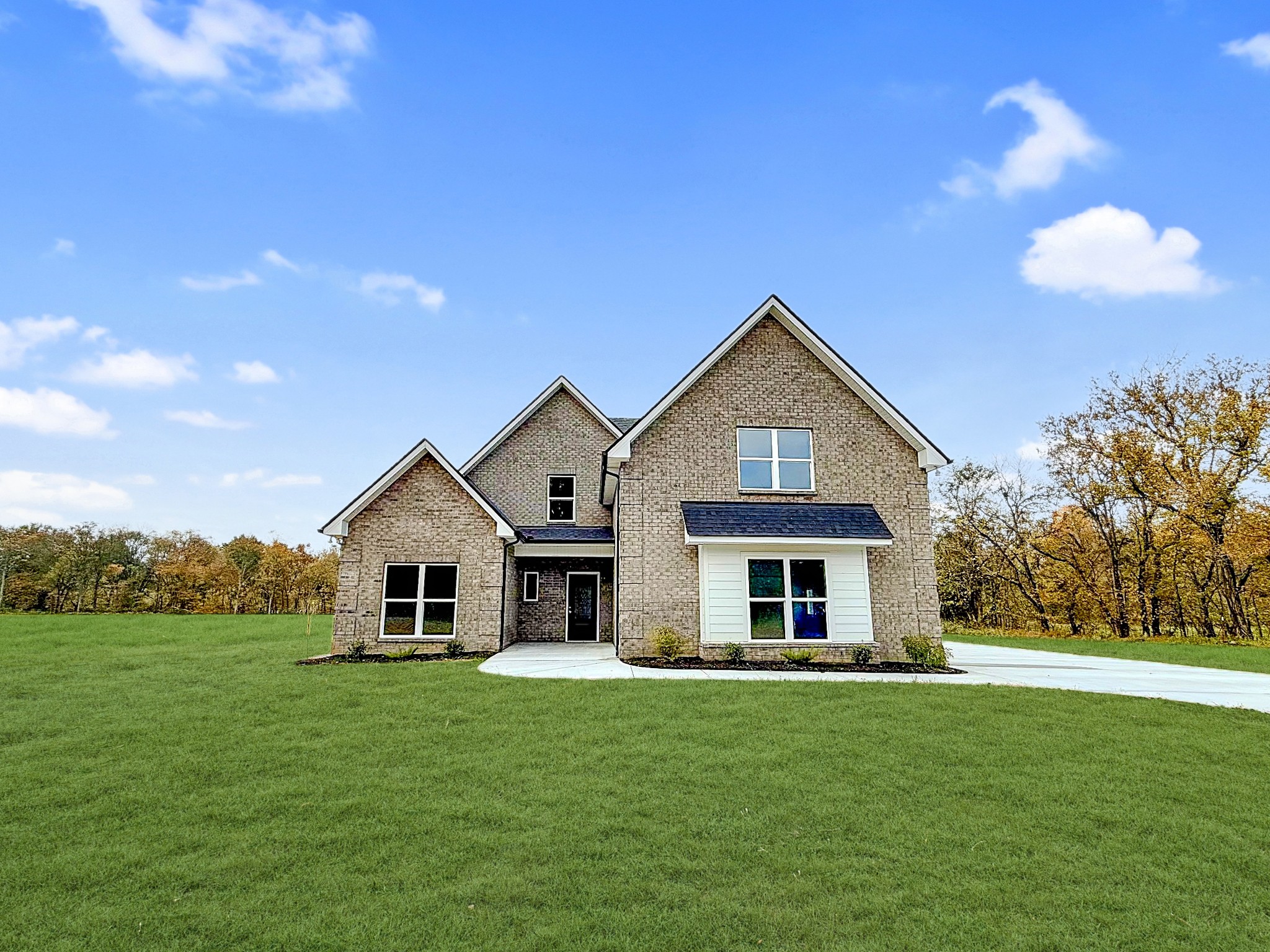 a front view of house with yard and green space