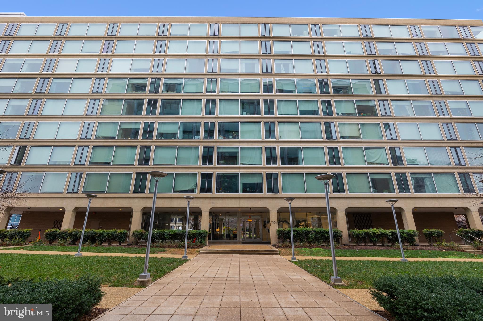 a view of a large building with a windows and pathway