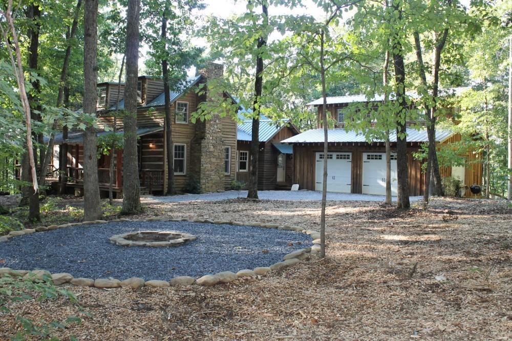 a front view of a house with a tree