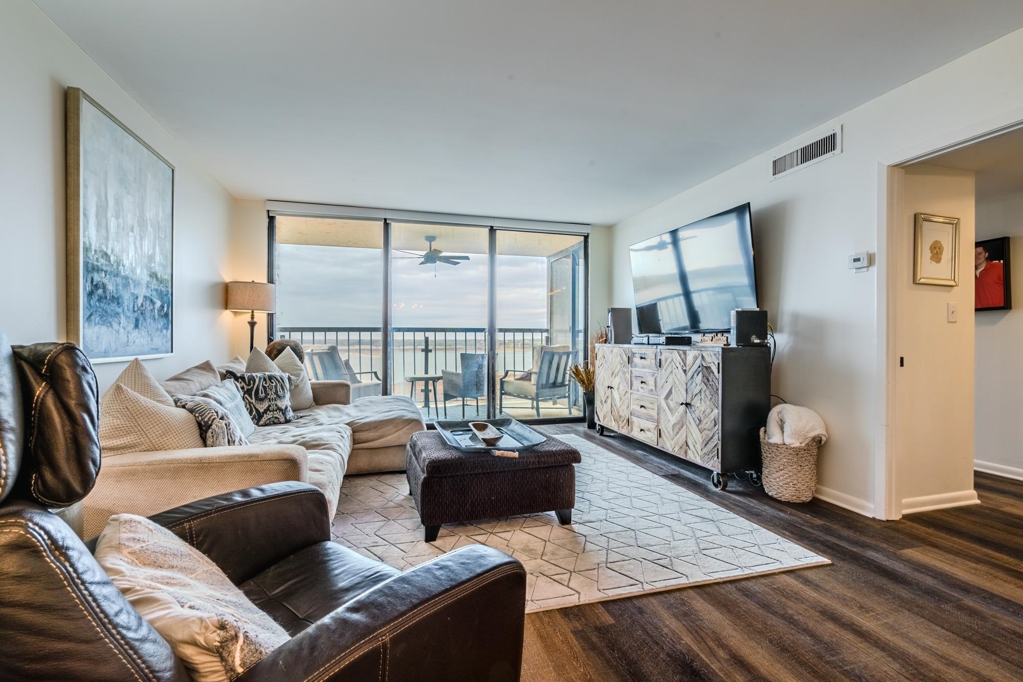 a living room with furniture and large windows