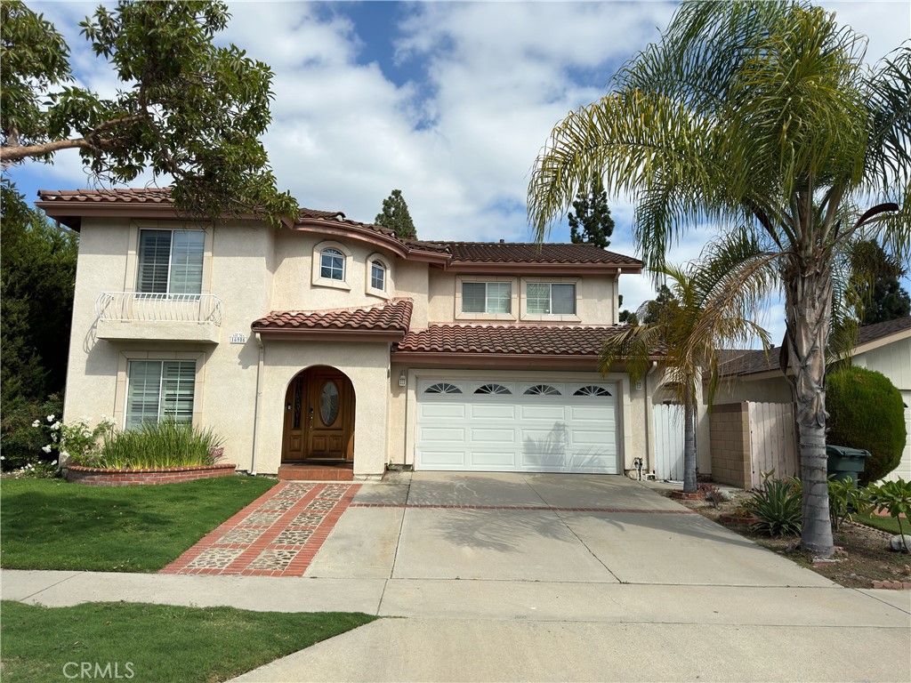 a front view of a house with a yard and a garage