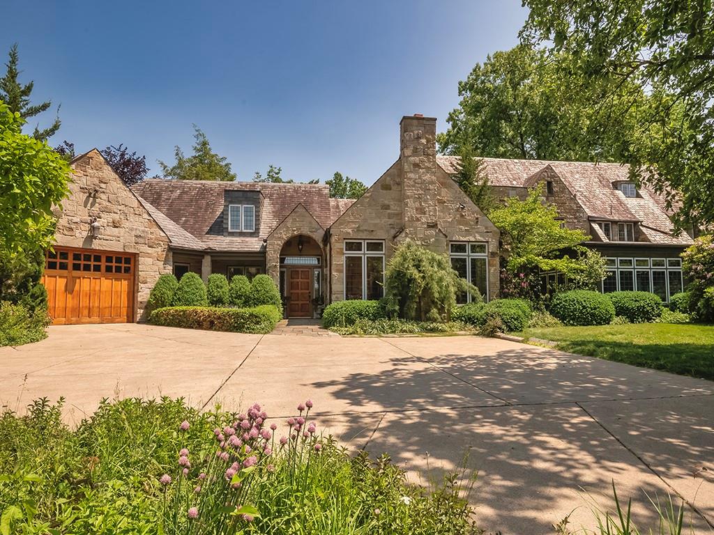 a front view of a house with a yard and a garage