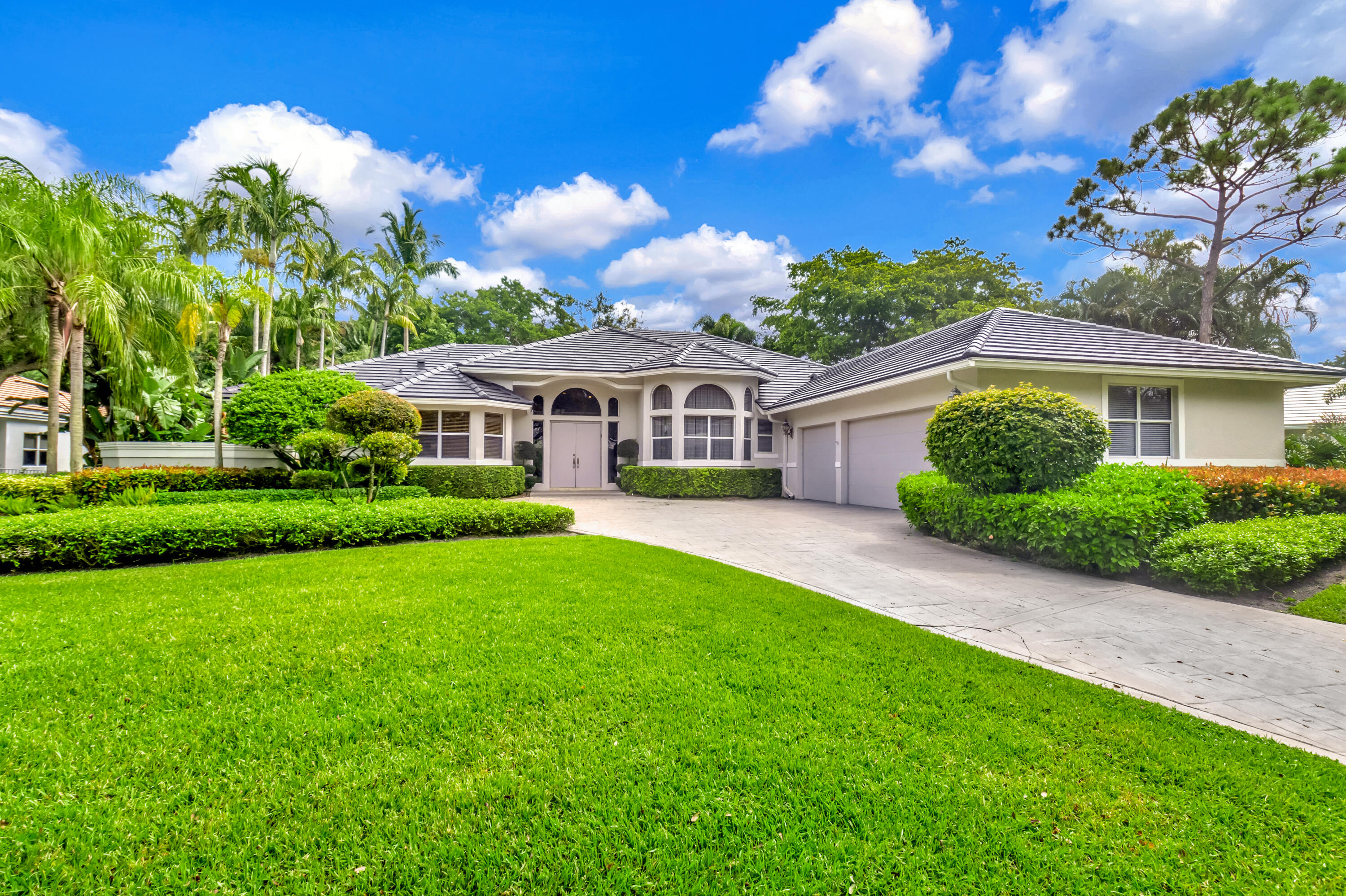 a front view of a house with a garden