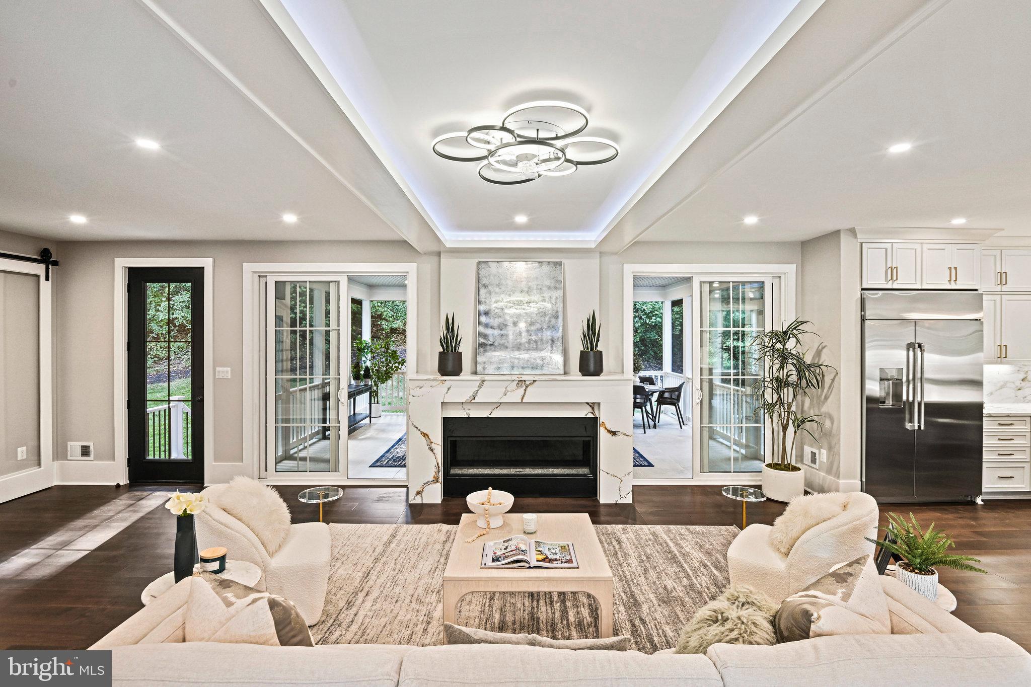 a living room with furniture fireplace and a large window