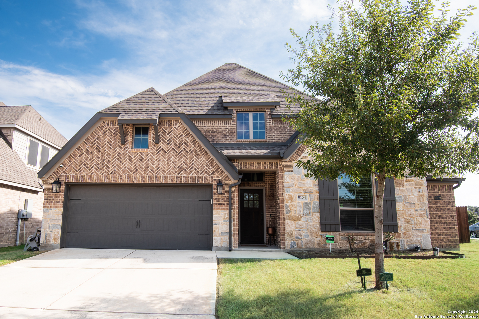 a front view of a house with garage