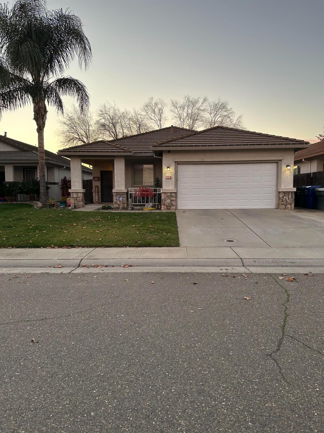 a view of a house with a yard and parking space