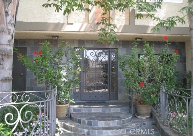 a front view of a house with plants