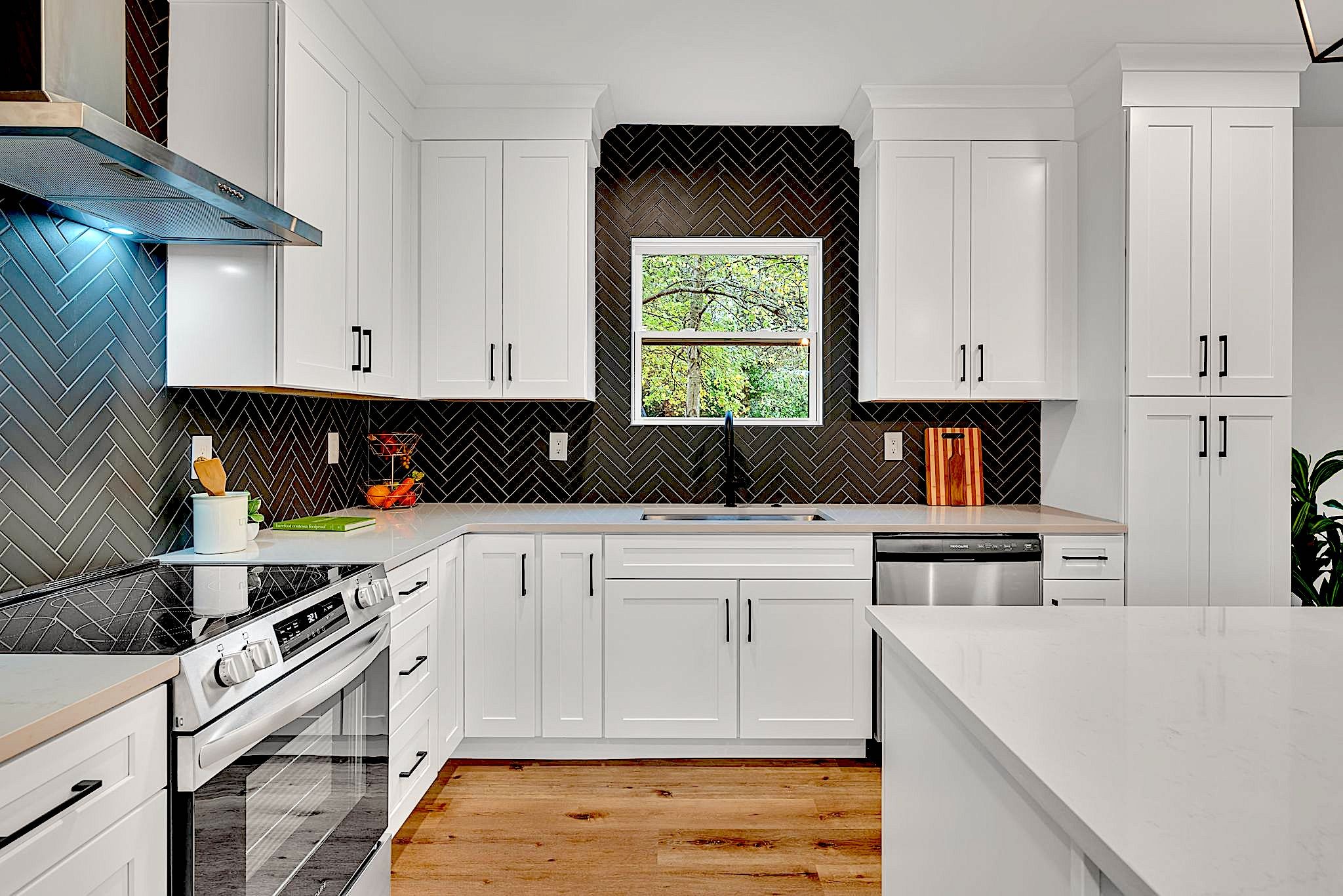 a kitchen with stainless steel appliances white cabinets sink and stove