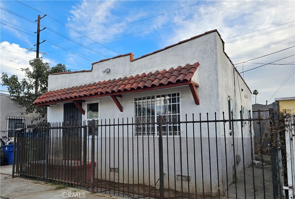 a view of a house with iron fence