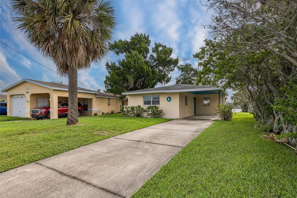 a front view of house with yard and green space