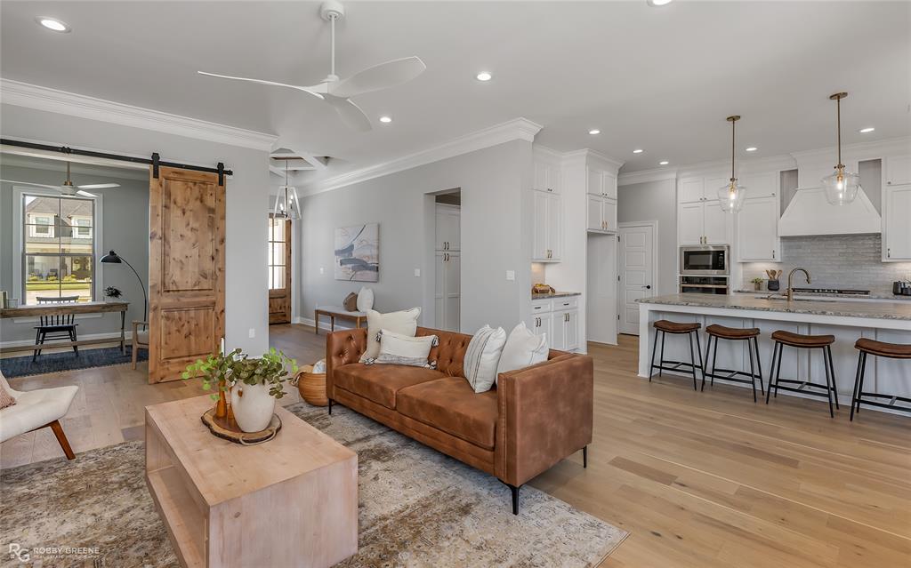 a living room with kitchen island furniture and a wooden floor