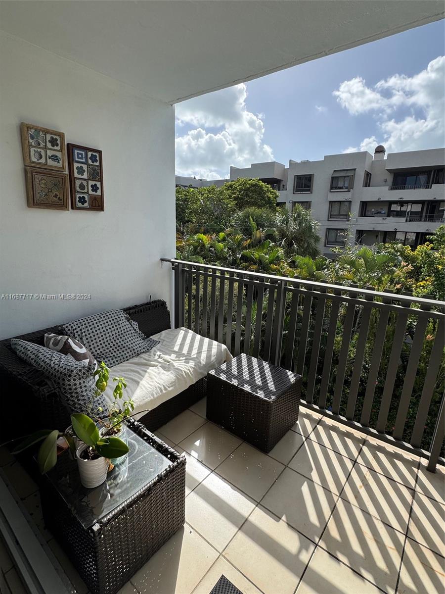 a roof deck with couches and potted plants