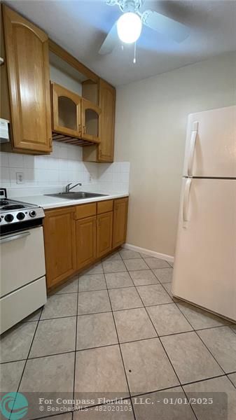 a kitchen with stainless steel appliances granite countertop a stove a microwave and a refrigerator