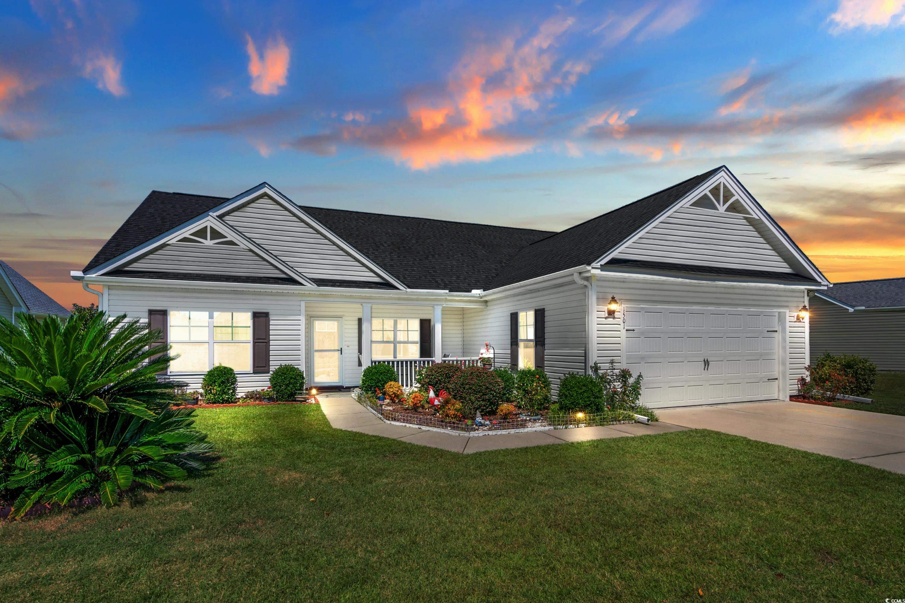 Ranch-style home featuring a garage, a porch, and