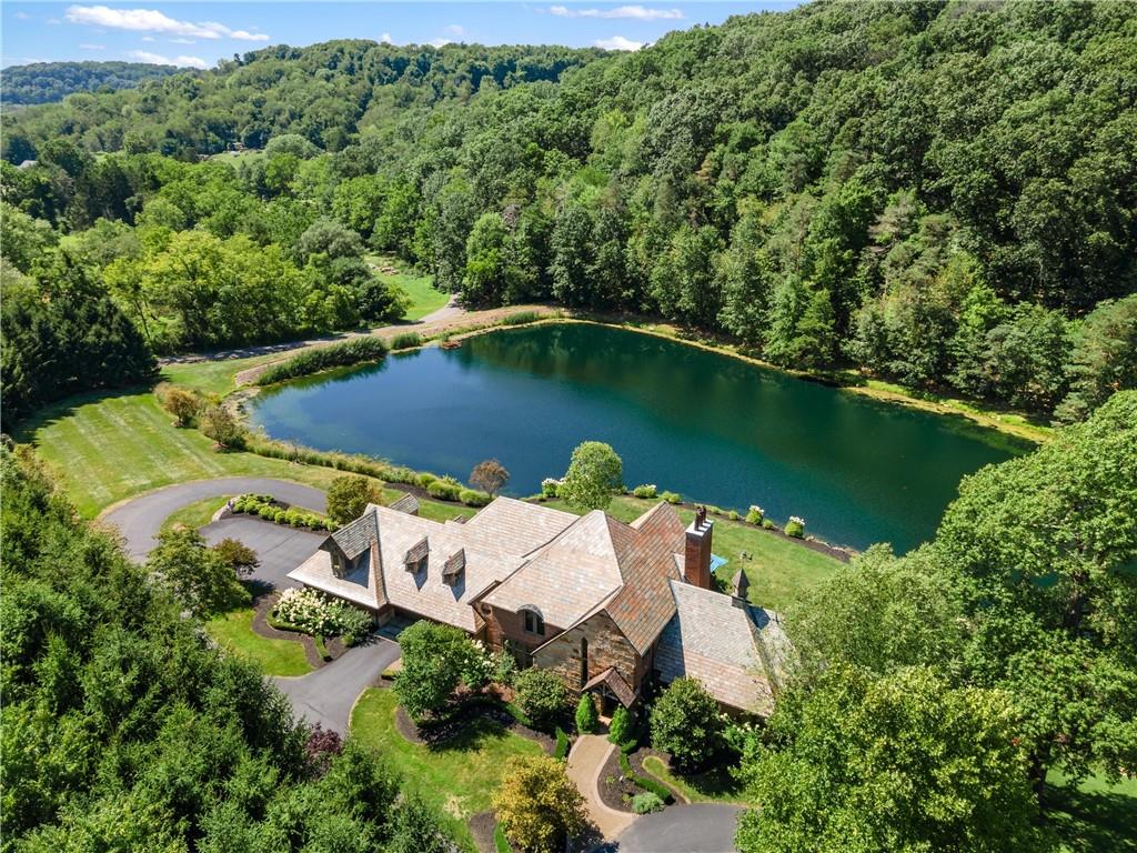 an aerial view of a house with swimming pool outdoor seating and yard