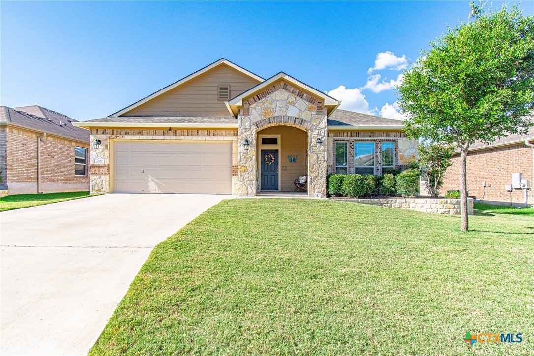 a front view of a house with a yard