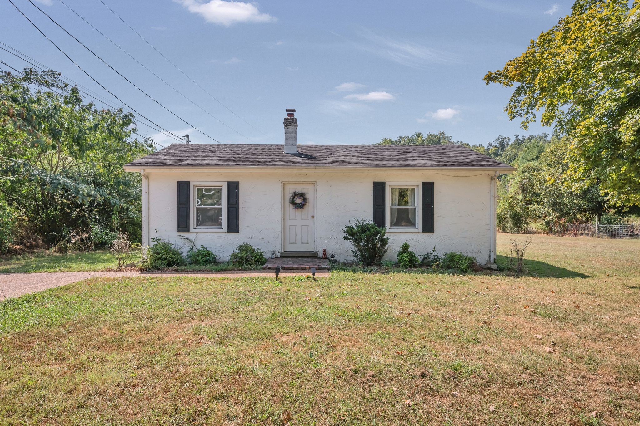 a front view of house with yard and green space