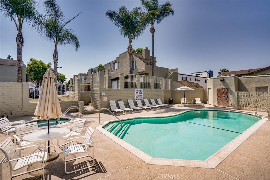 a view of a swimming pool with a patio and a garden