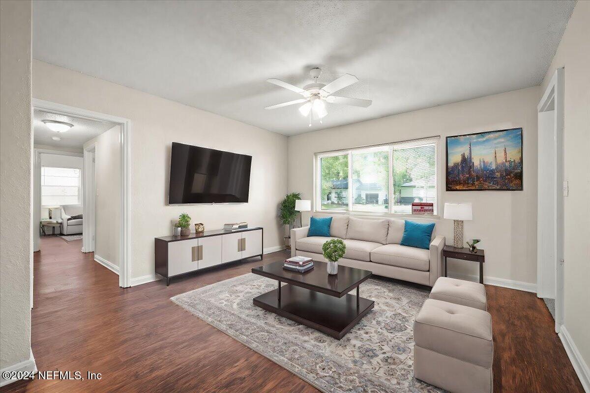 a living room with furniture fireplace and a flat screen tv