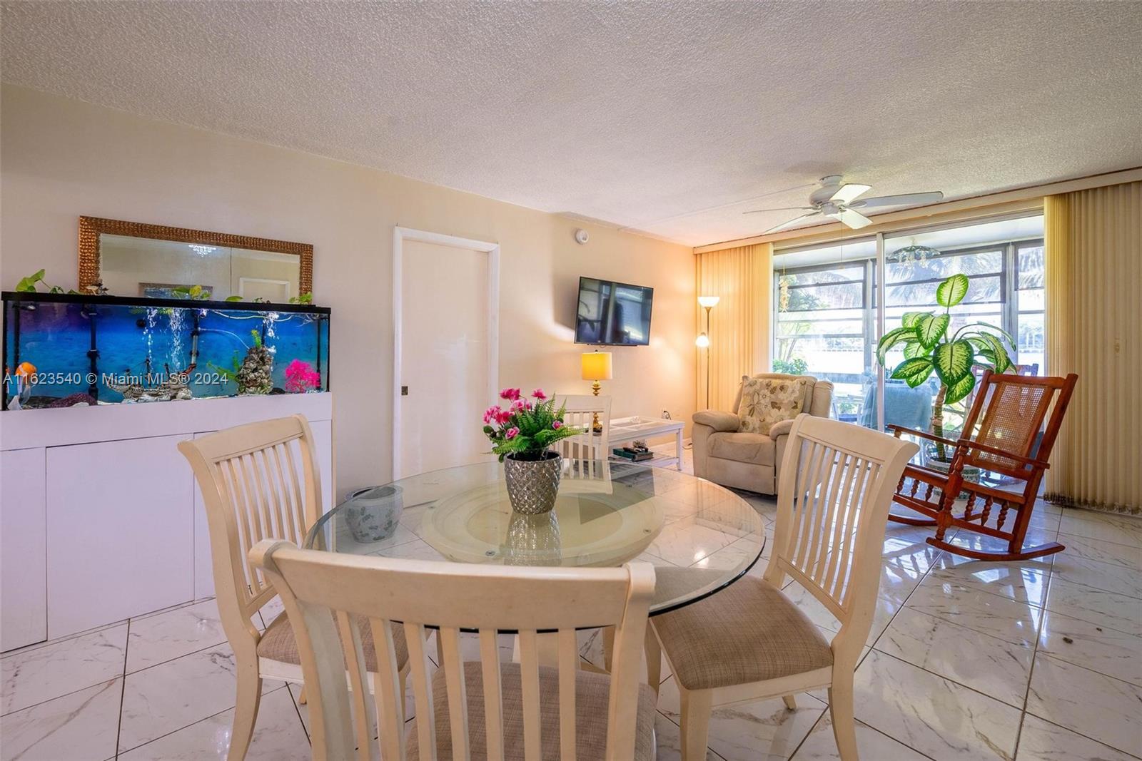 a dining room with furniture and a potted plant