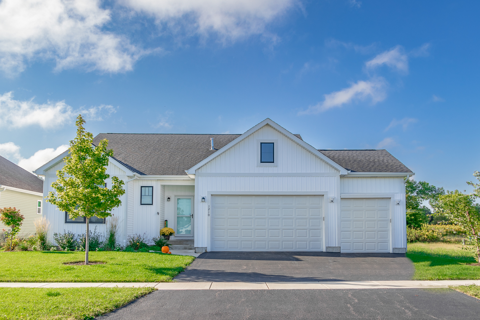 a front view of a house with a yard and garage