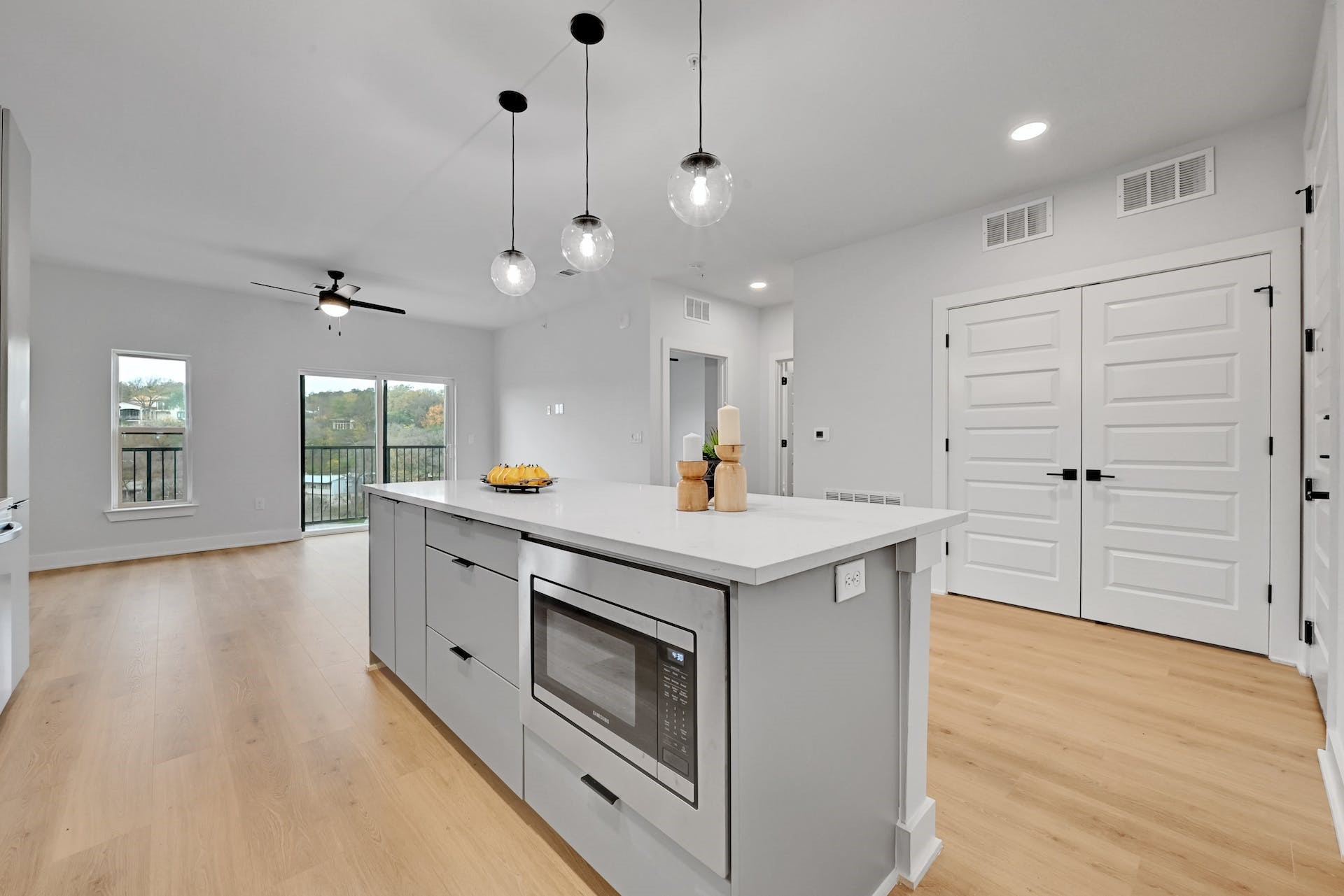 a kitchen with a stove and a wooden floor