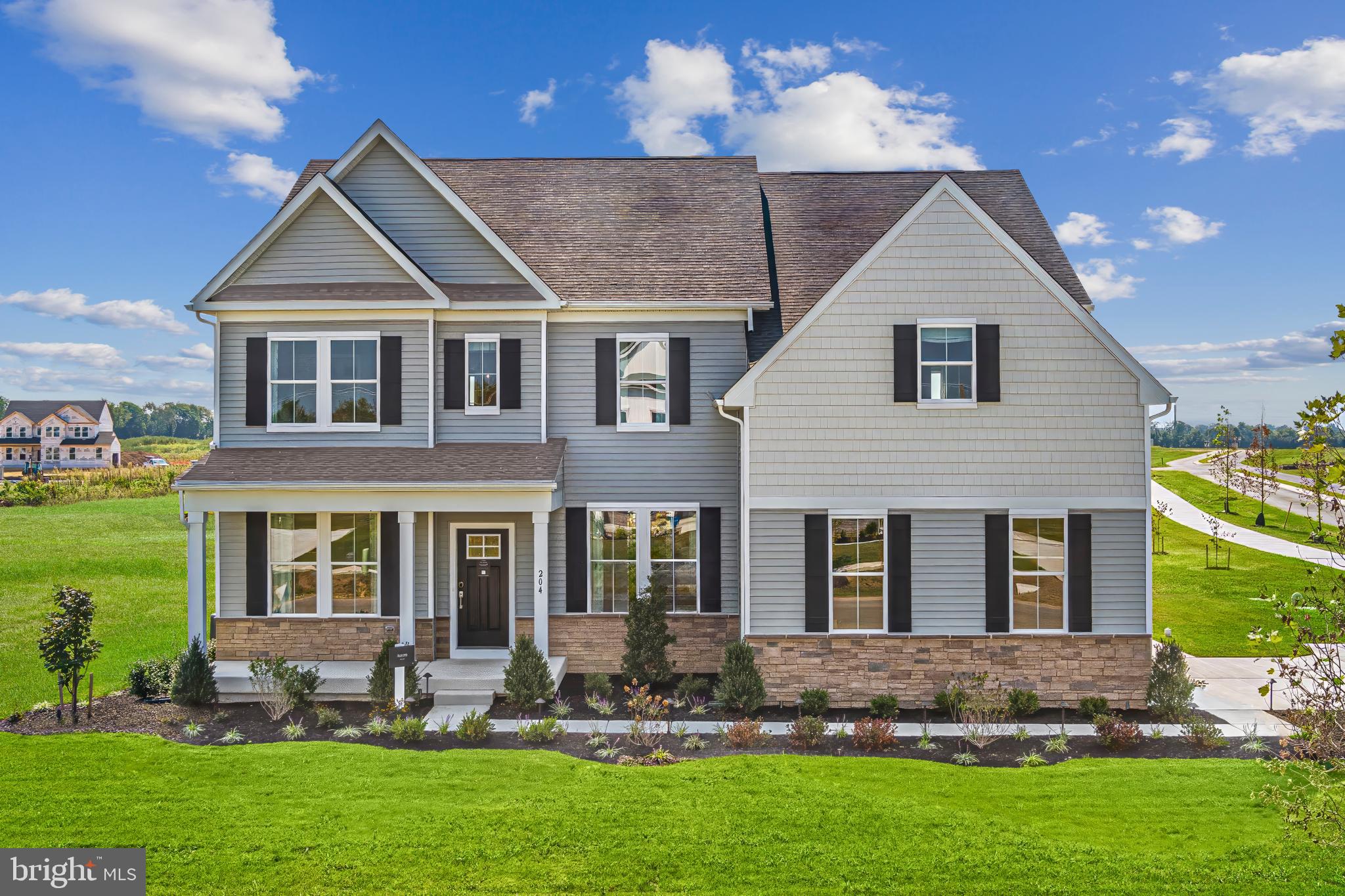 a front view of a house with a yard and outdoor seating